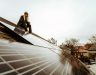 Woman posing on the roof with her new solar panels