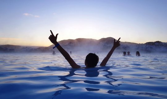 Person enjoying hot springs on a dream vacation.