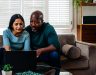 Husband and wife using computer to research types of personal loans