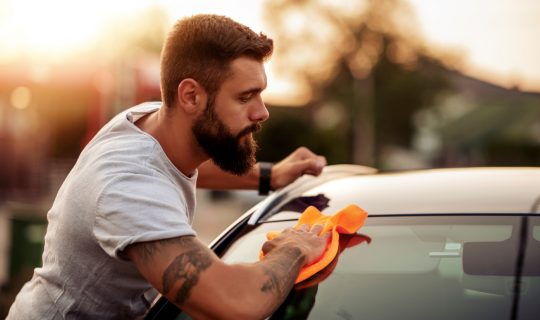 Man saves on car maintenance by washing his own car